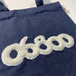 TOTE BAG DENIM CON TELA DE BORREGUITO CRUDO BORDADO