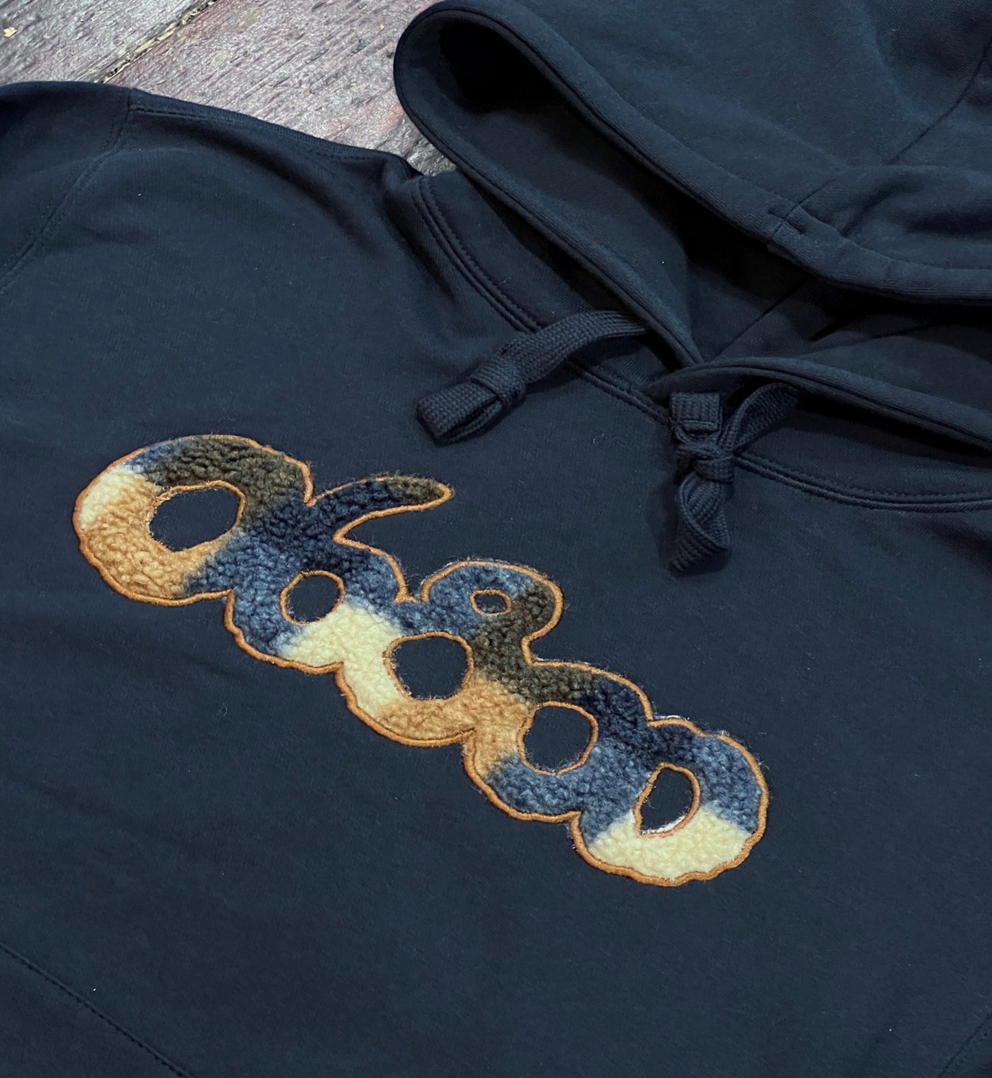 SUDADERA AZUL MARINO CON TELA DE BORREGUITO A CUADROS Y BORDADO